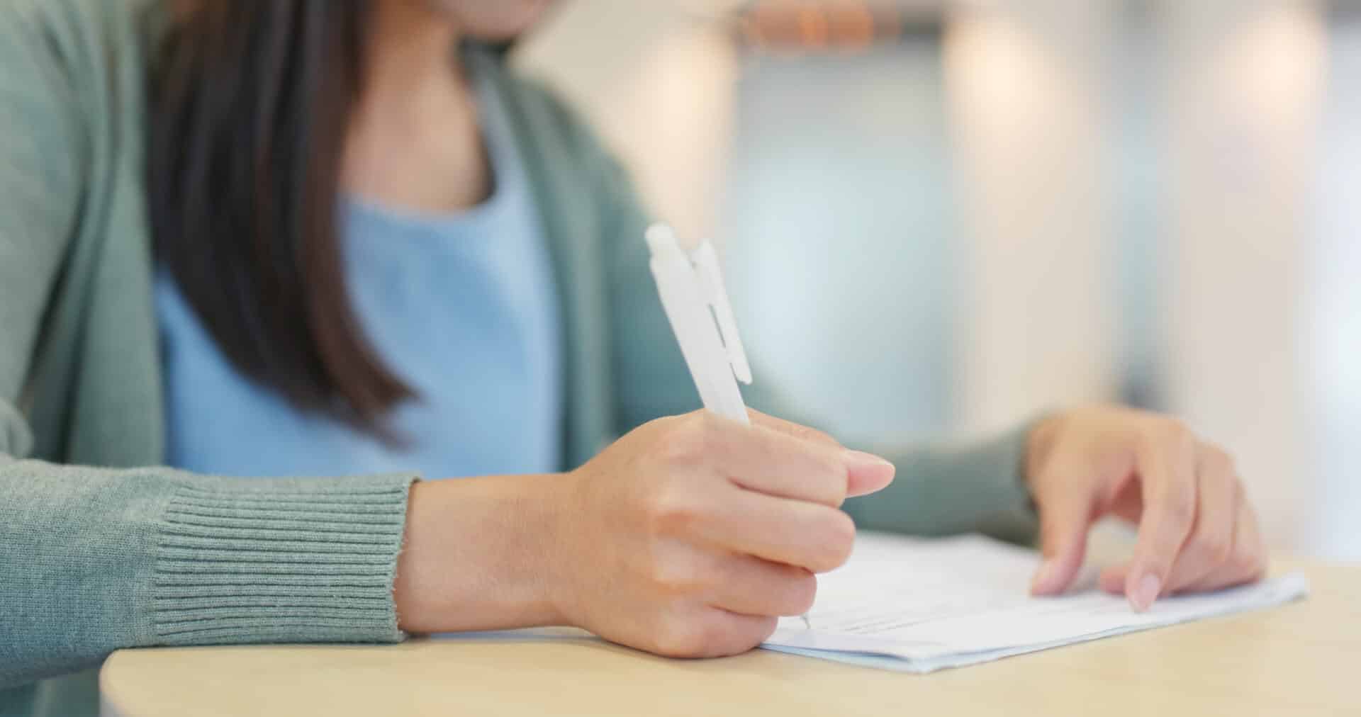 Student writing note at school