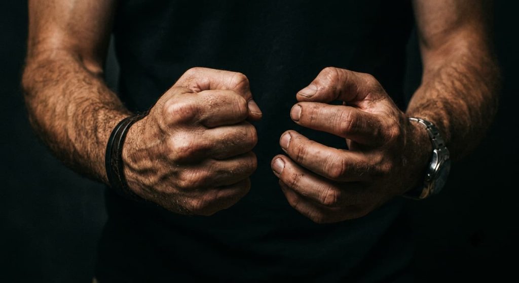 Man with clenched fists representing heat of passion and provocation in a New Jersey manslaughter case